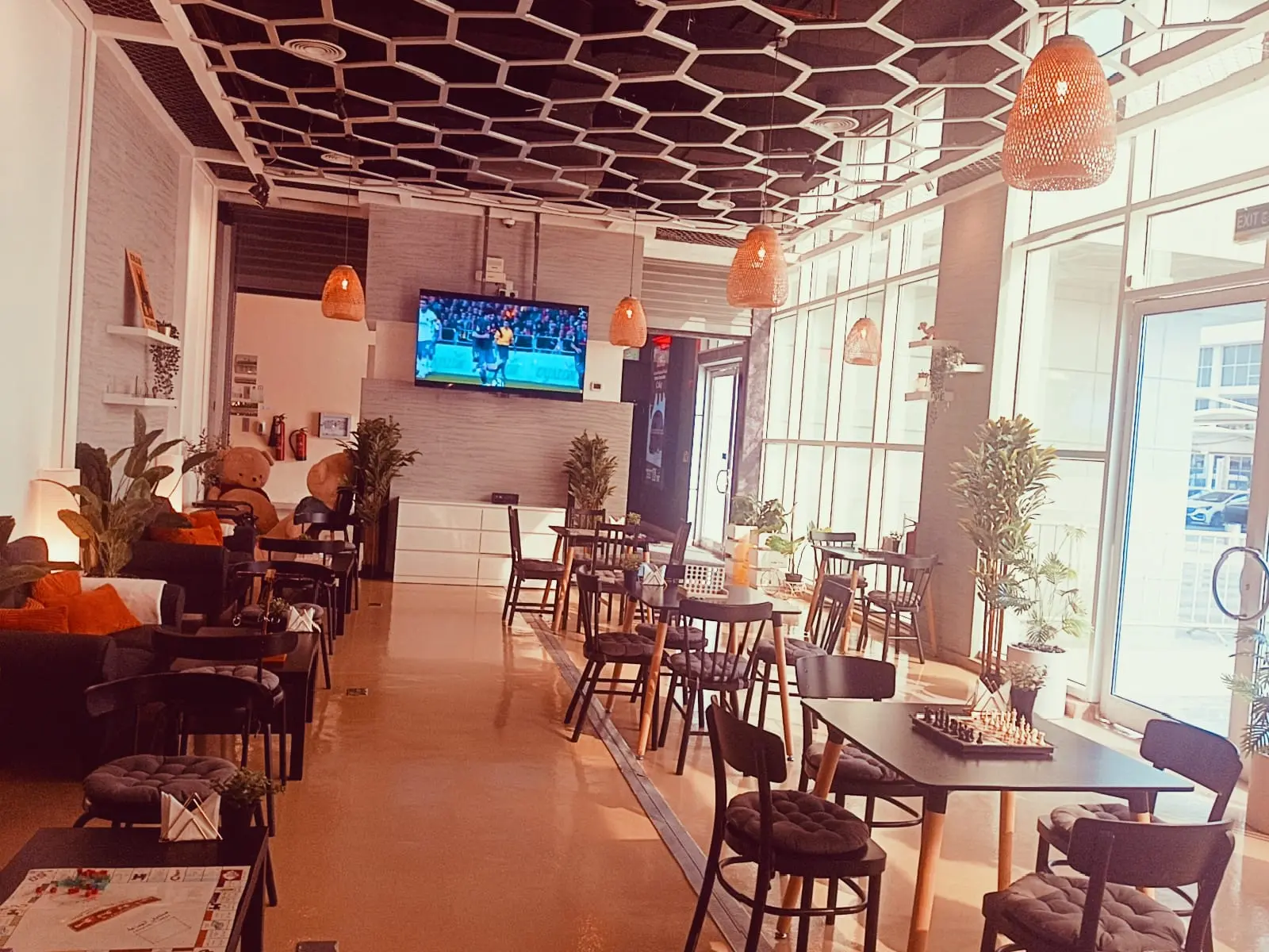 Warm evening light in the café with a football match on the screen